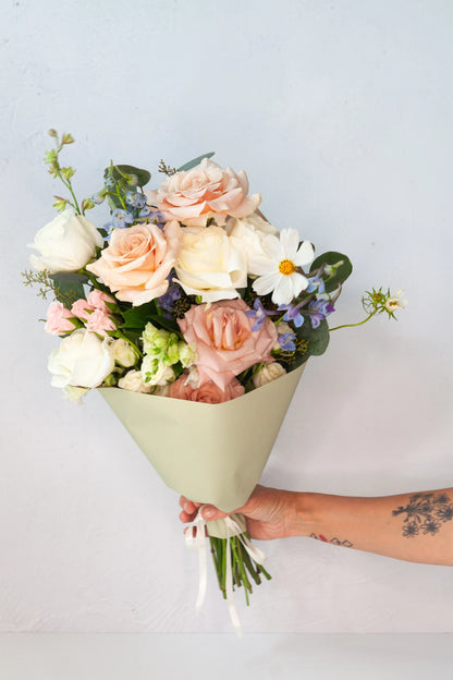 Wrapped bouquet with pastel tones from a flower shop in Austin, Texas.