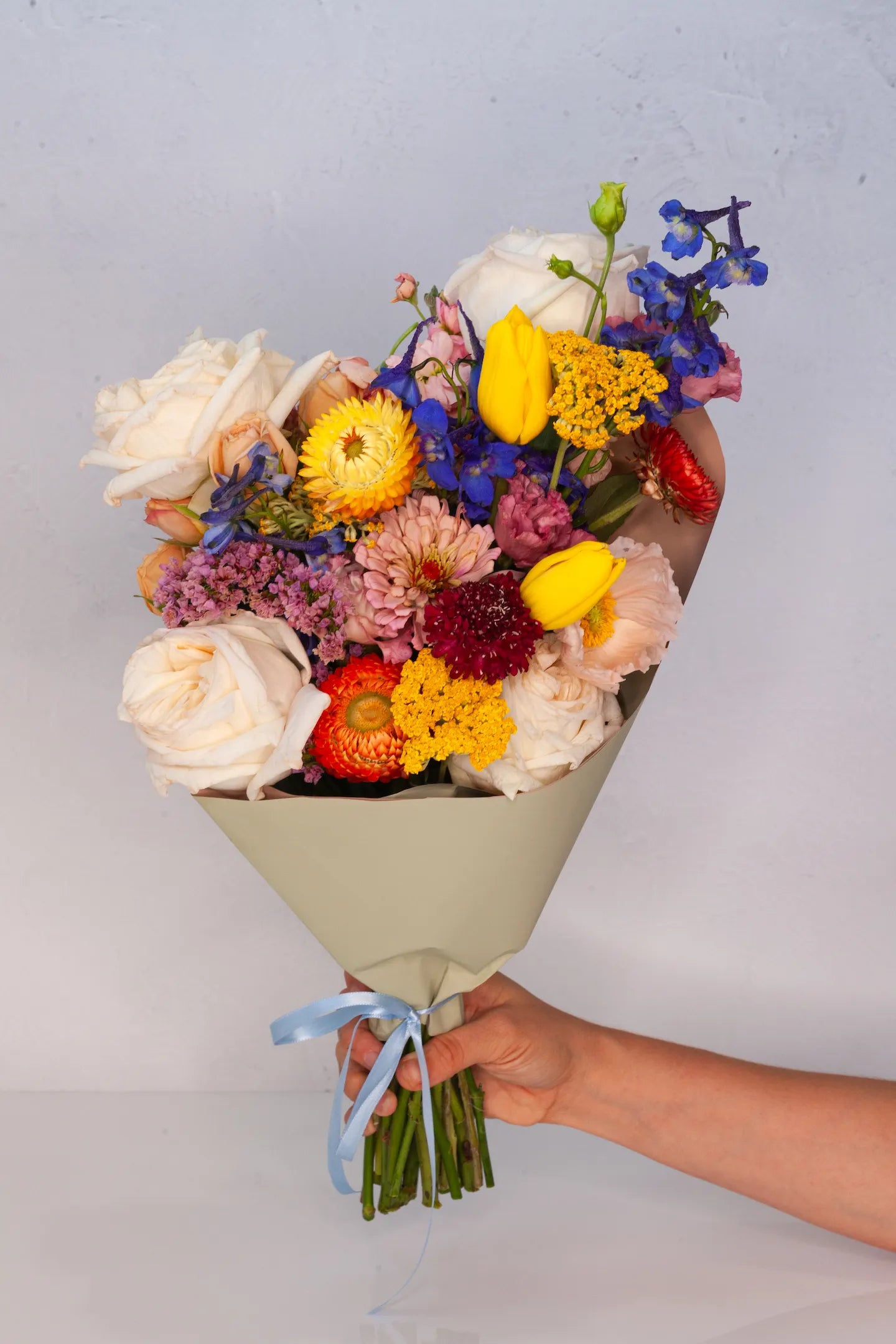 Large wrapped bouquet with colorful flowers from a shop in Austin, Texas.