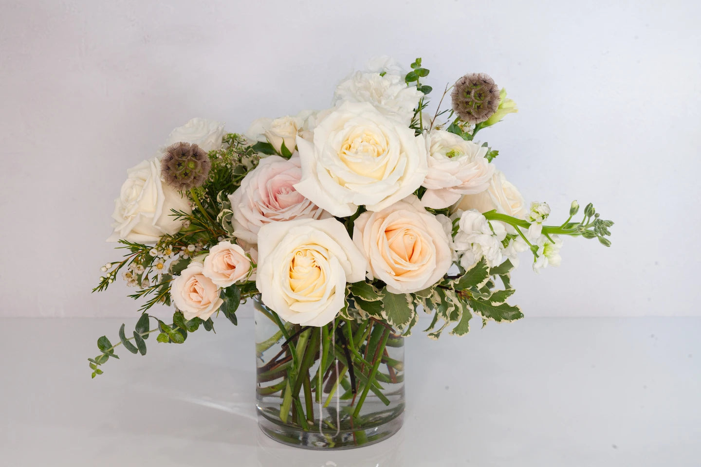 Lush garden floral arrangement with white flowers.