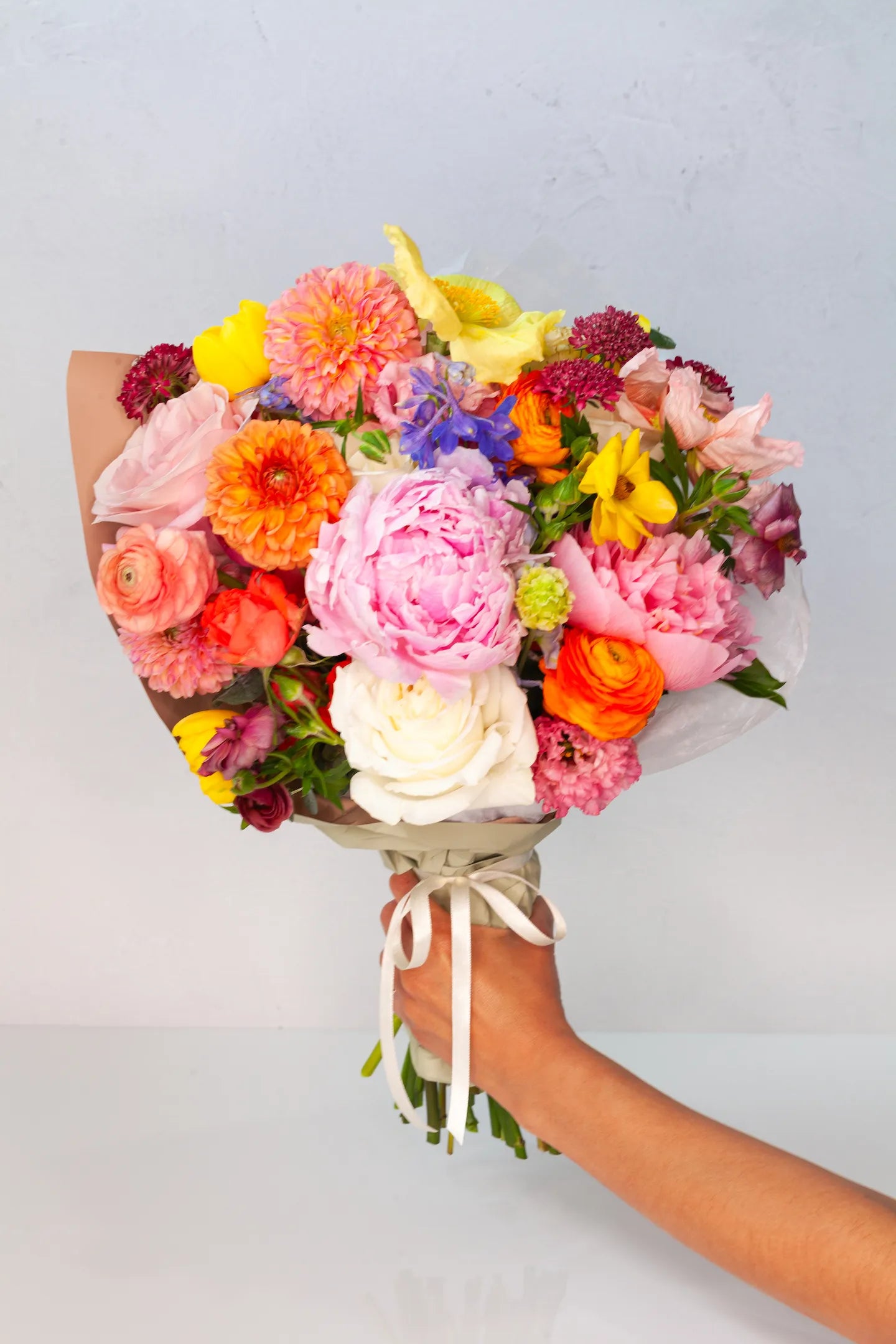 Deluxe wrapped bouquet with colorful flowers, designed by Verbena Floral Design.