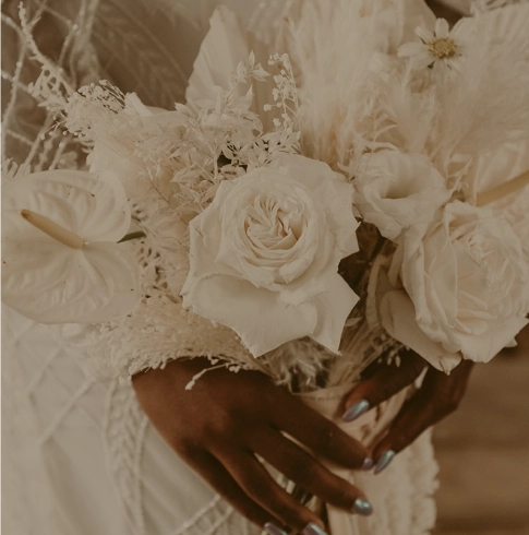 Close-up of a bride holding a custom wedding bouquet from Verbena in Austin.